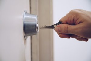 Key To Padlock In Hand Photo