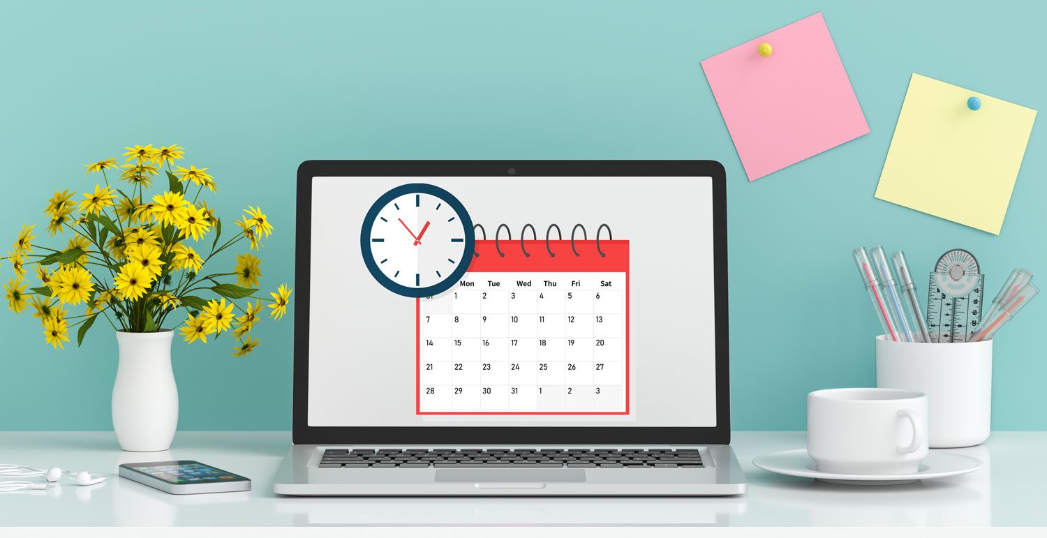 Computer on a desk with a calendar and clock on the screen